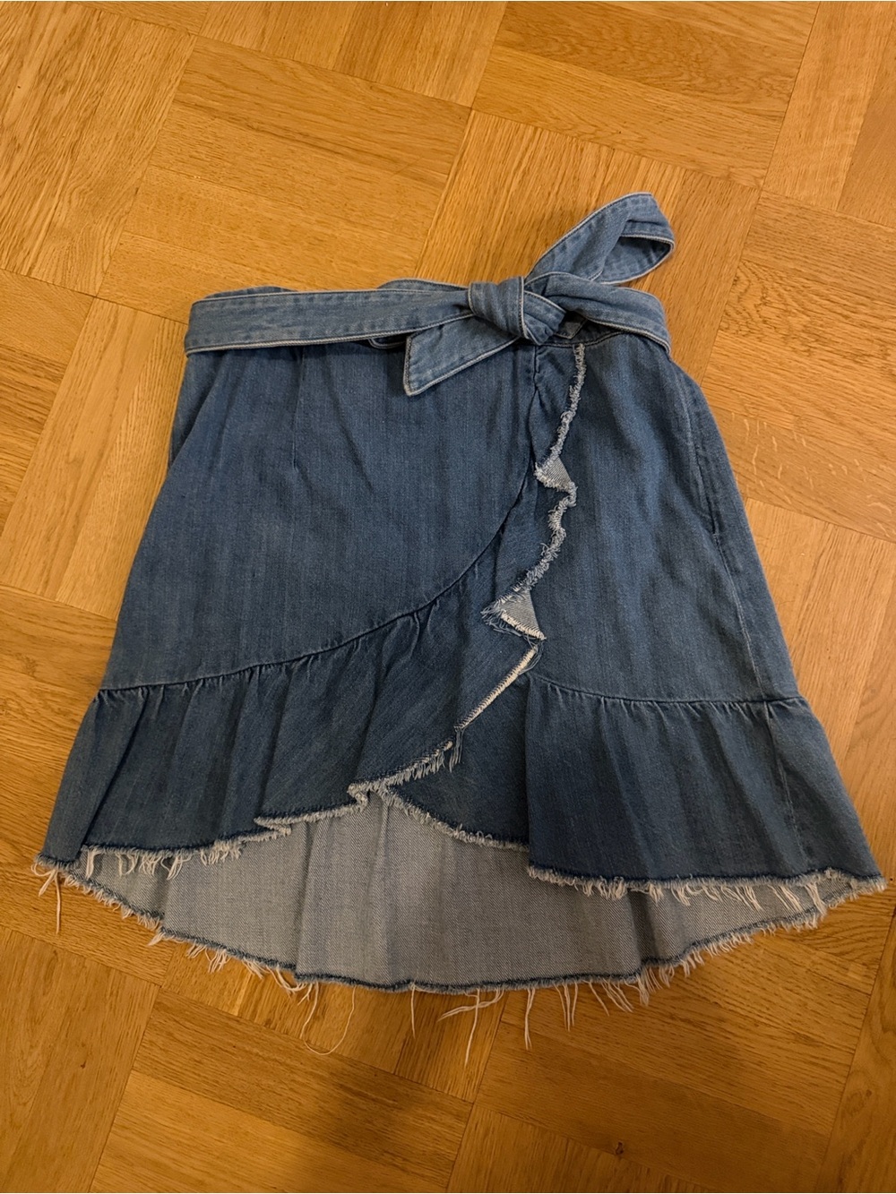 PAIGE faded blue denim mini skirt with ruffle hem